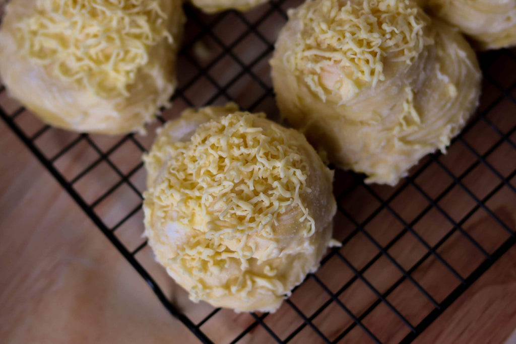 Mangan Express Cheese Ensaymada in Houston, Texas USA- a soft and moist Filipino soft dough pastry covered with butter, sugar and grated cheese